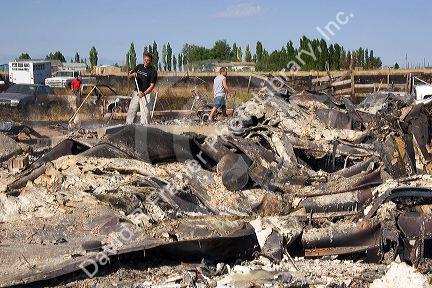 Victims sift through the ashes of a house fire caused by wildfire near Mountain Home, Idaho.