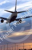 Airplane landing at LAX airport in Los Angelas, California at sunset.