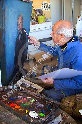 An artist painting a portrait on canvas in Boise, Idaho. MR