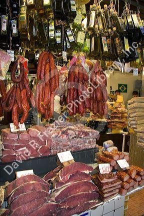 Cured meats, sausages, and olive oil being sold at the Mercado Municipal in Sao Paulo, Brazil.