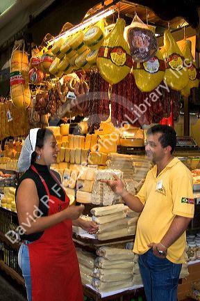 Woman selling cheese and sausages at the Mercado Municipal in Sao Paulo, Brazil.
