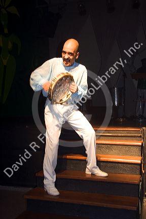 A man plays the tambourine at a nightclub in Sao Paulo, Brazil.