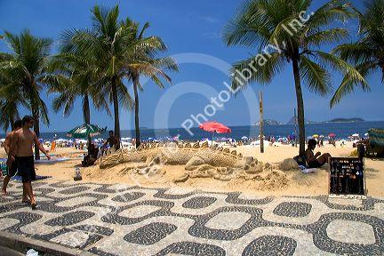 Alligator dragon sand sculpture at Ipanema Beach in Rio de Janeiro, Brazil.