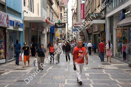People and store fronts on a walking street in Sao Paulo, Brazil.