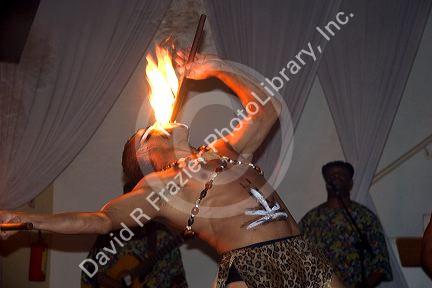 A dancer eating fire at a nightclub in Sao Paulo, Brazil.