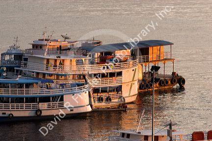Amazon river boats docked at sunrise in Manaus, Brazil.