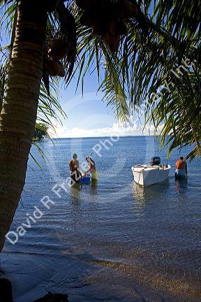 Fishermen in the lagoon of the island of Tahiti.