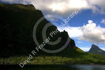 Band of sunlight shines on a house along Opunohu Bay on the island of Moorea.