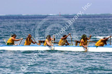 Tahitian women take part in an outrigger canoe pirogue race off the island of Moorea.