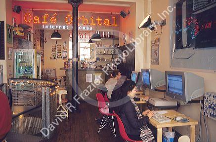 People using computers in an internet cafe.  Paris, France.