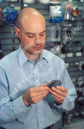 Radio Shack emplyee changing the batteries in an MP3 player.