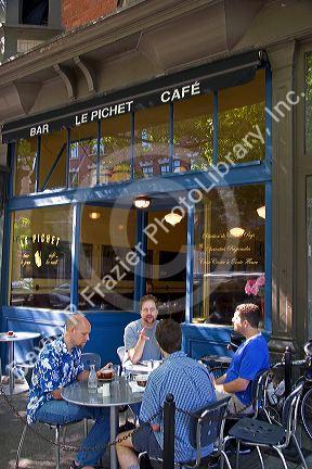 Men socialize at an outdoor cafe in Seattle, Washington.
