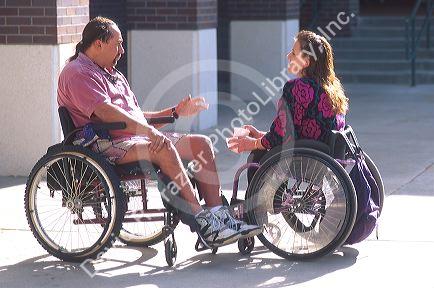 Handicapped woman and man conversing.