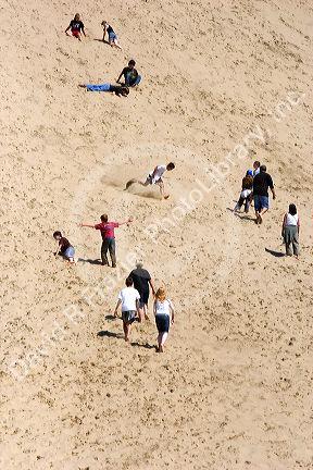 People play on the sand dunes at Pacific City on the Oregon Coast.