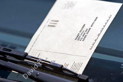 A parking ticket on the windshield of a car in Boise, Idaho.