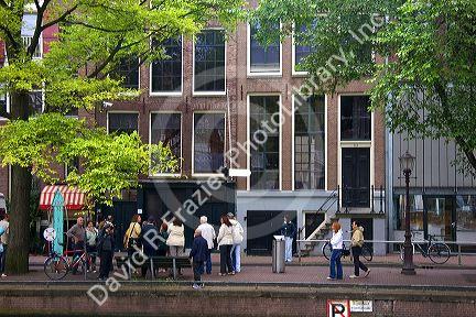 People stand in front of the Anne Frank House in Amsterdam, Netherlands.