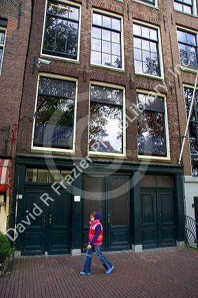 A young girl walks past the Anne Frank House in Amsterdam, Netherlands.