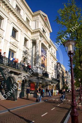 People stand in front of the Royal Carre Theatre in Amsterdam, Netherlands.