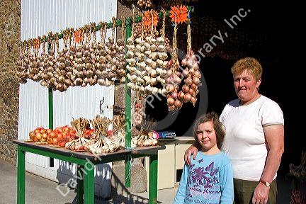 French woman selling garlic at Saint-Broladre in the  Brittany  province of France.