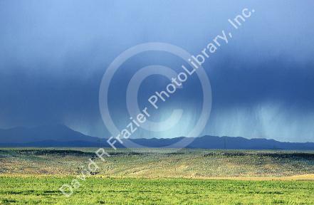 Rain clouds over Idaho mountains and desert near Boise.