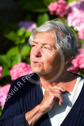 Elderly french woman in the commune of Barfleur in the region of Basse-Normandie, France.