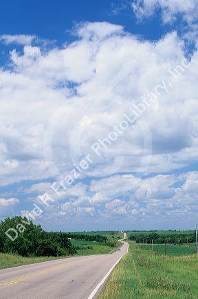 A two lane  country road in rural Iowa.
