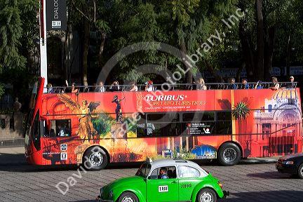 Double decker Turibus and Taxi on the Paseo del la Reforma in Mexico City, Mexico.