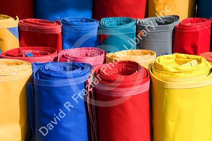 Rolls of colored canvas being sold at the Merced Market in Mexico City, Mexico.