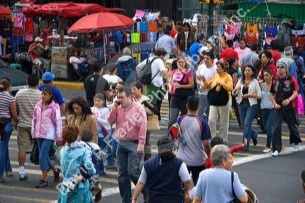 Pedestrians cross the street at the intersection of Paseo de la Reforma and Eje Central Lazaro Cardenas in Mexico City, Mexico.