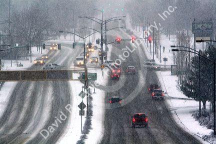 Automobiles driving on a snowy day in Boise, Idaho.