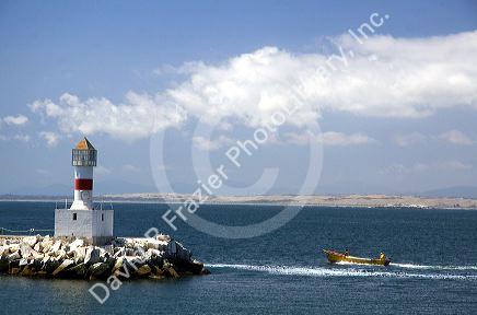 Lighthouse and boat off the coast of Concon in the Valparaiso Region of Chile.