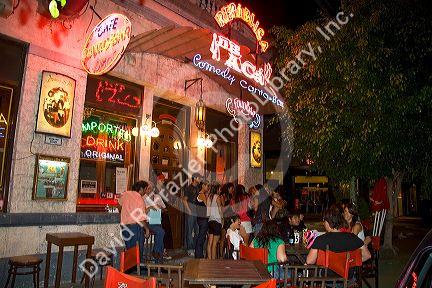 People gather and socialize in front of a bar in Buenos Aires, Argentina.