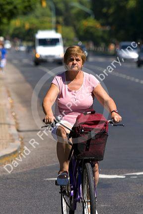 Woman riding a bicycle in Buenos Aires, Argentina.