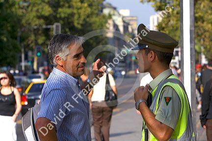 Chilean man speaking to a police officer in Santiago, Chile.