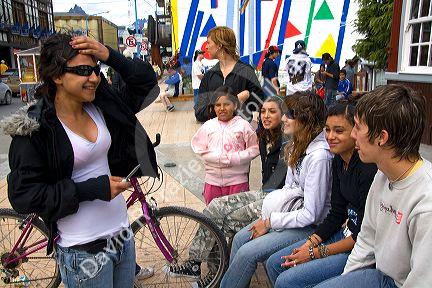 Teens socialize in front of the tourist information center at Ushuaia on the island of Tierra del Fuego, Argentina.