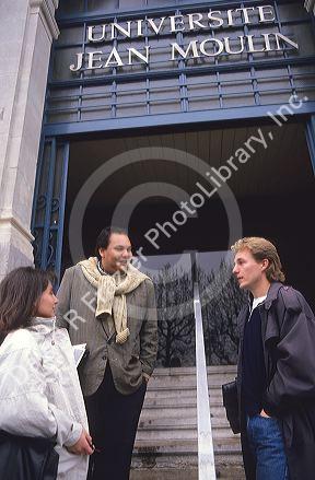 College students talk with a professor at the University in Lyon in France.
