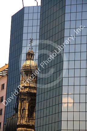 Reflection of the Metropolitain Cathedral in a modern office building located in the Plaza de Armas in Santiago, Chile.