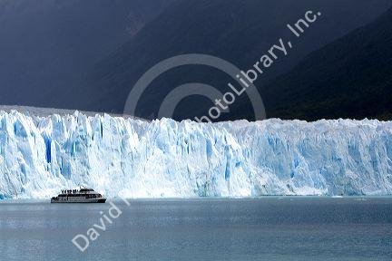 Tour boat in front of the Perito Moreno Glacier located in the Los Glaciares National Park in the south west of Santa Cruz province, Patagonia, Argentina.