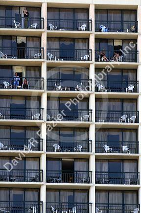 People on balconies of hotel rooms at Galveston Beach in Galveston, Texas.