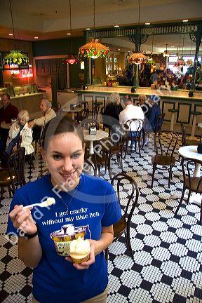 Employee with ice cream at the Blue Bell Creamery in Brenham, Texas.