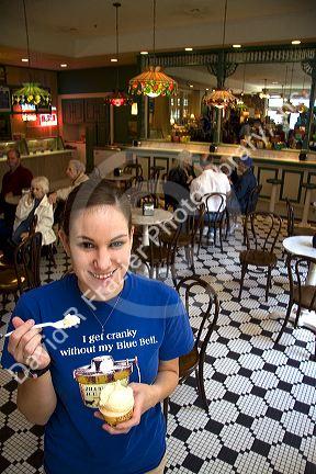 Employee with ice cream at the Blue Bell Creamery in Brenham, Texas.