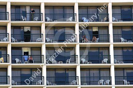 People on balconies of hotel rooms at Galveston Beach in Galveston, Texas.