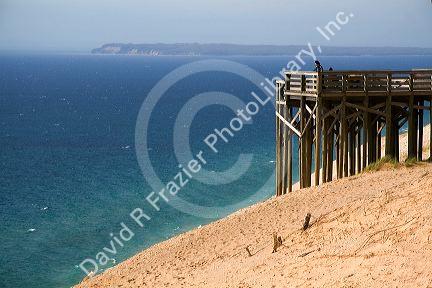 People stand on a viewing platform on the banks of Lake Michigan in Sleeping Bear Dunes National Lakeshore located along the northwest coast of the Lower Peninsula of Michigan.