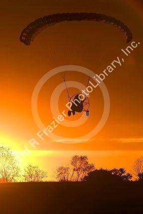 Powered parachute flying at sunset in Eaton County, Michigan.