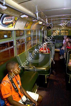 Black boy sits in Rosa Parks city bus seat on display at The Henry Ford Museum in Dearborn, Michigan.