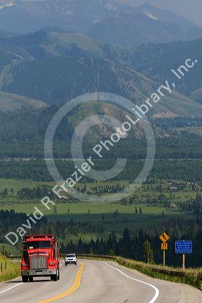 Dump truck traveling over the high mountain Teton Pass on Wyoming Highway 22 near the state border of Wyoming and Idaho.