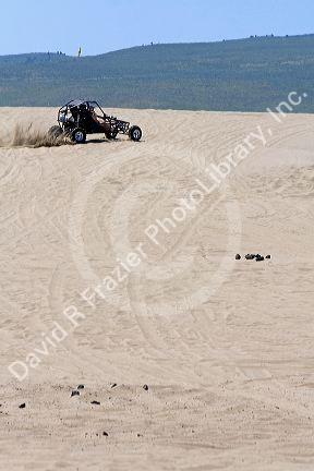 Dune buggy driving on sand dunes at St. Anthony, Idaho.