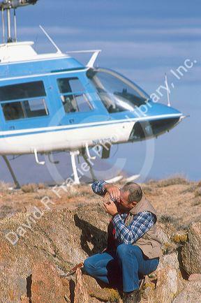 Minerologist examines a rock in the field.