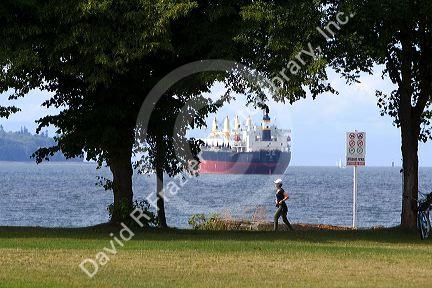 Woman jogging along the Seawall in Stanley Park at Vancouver, British Columbia, Canada.