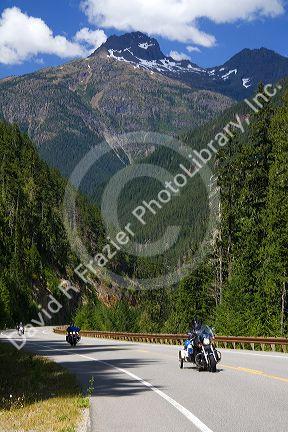 Motorcycles travel on Washington State Highway 20 in the North Cascade Range, Washington.